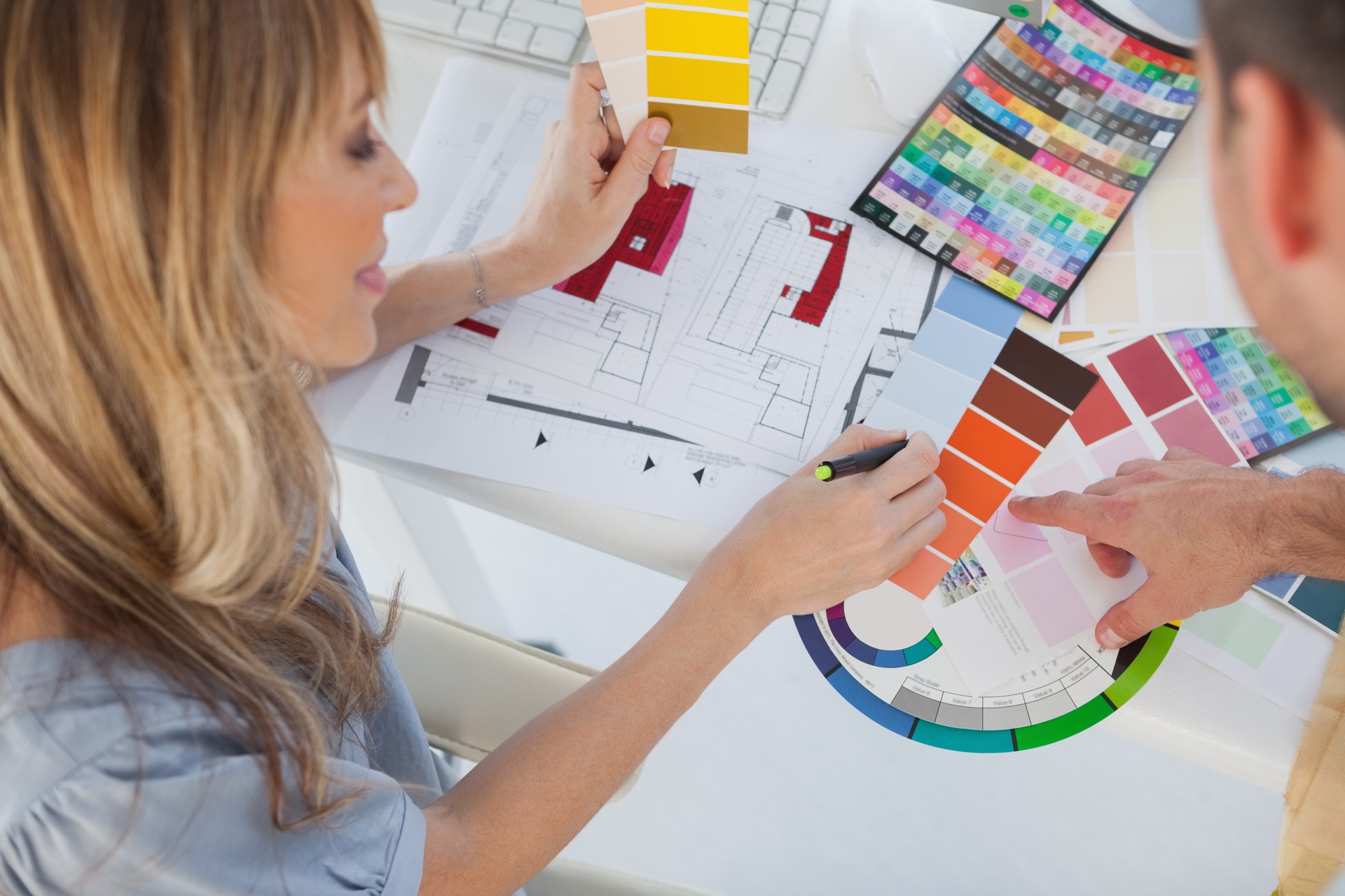 Interior designers pointing at a colour chart